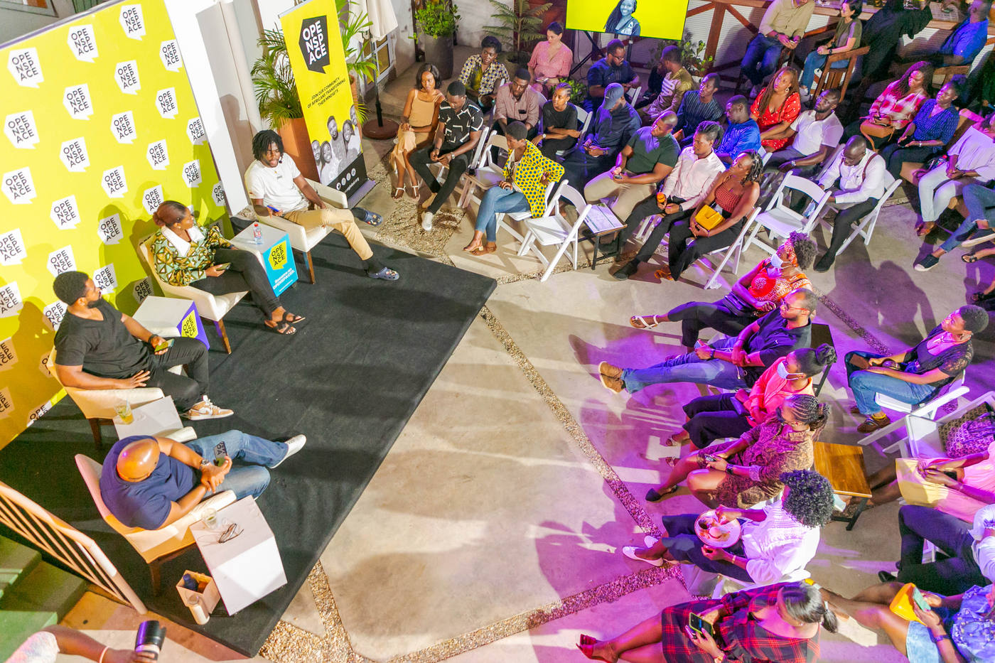 Members seated in a wide circle in conversation